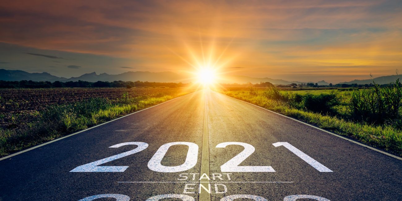 New year 2021 or start straight concept.word 2021 written on the road in the middle of asphalt road at sunset.Concept of planning and challenge or career path,business strategy,opportunity and change